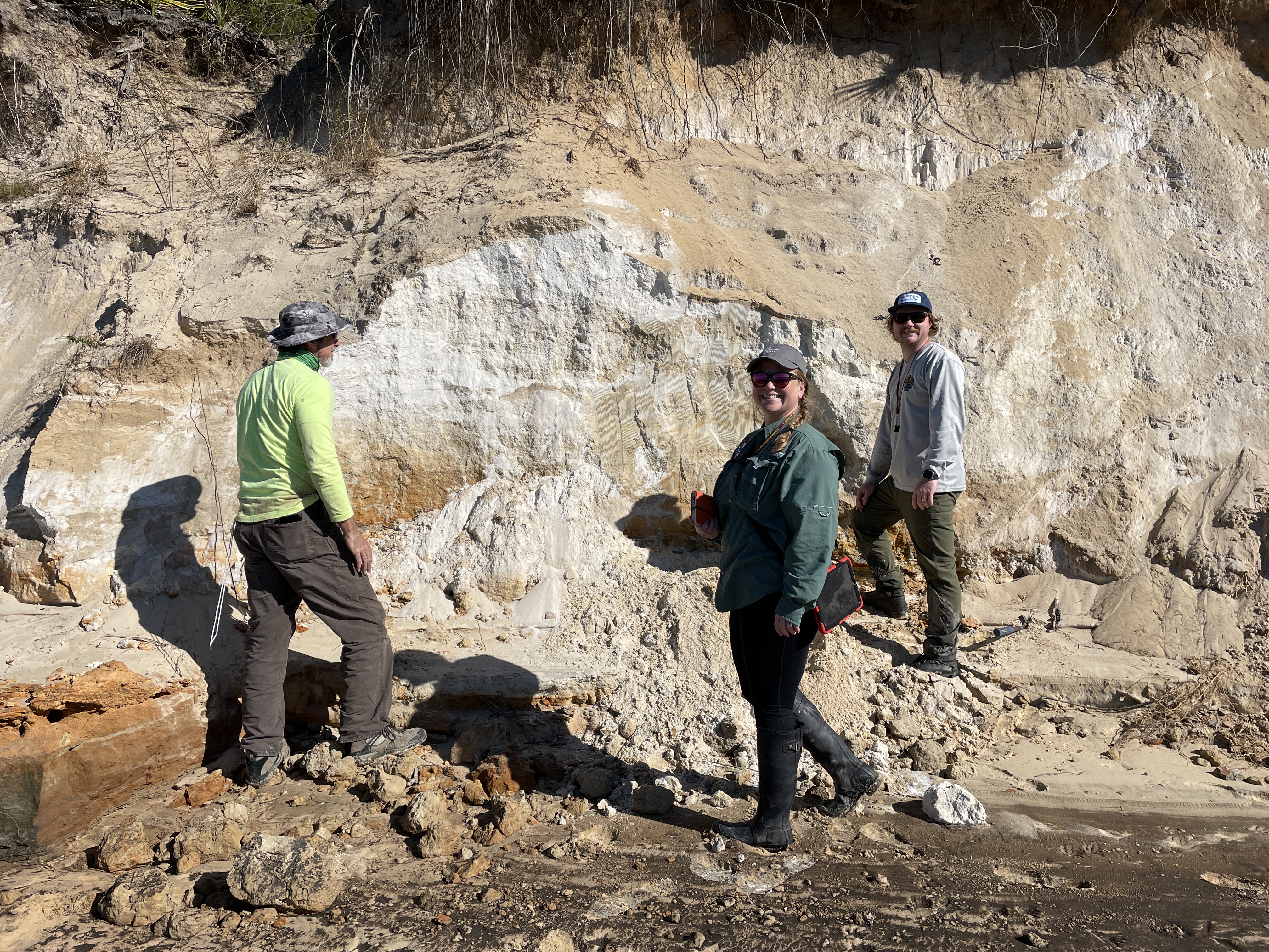 Geologists examining outcrop