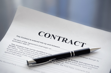 Black pen laying on top of document that says Contract