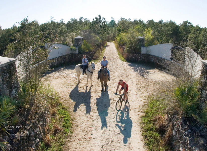 Two equestrians and a biker at the Land Bridge on the Cross Florida Greenway