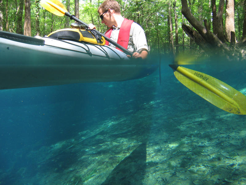 A paddler on crystal clear water at a Chipola River Spring