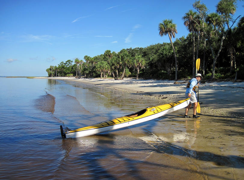 Man pulling his kayak ashore on Pig Pine Island Florida