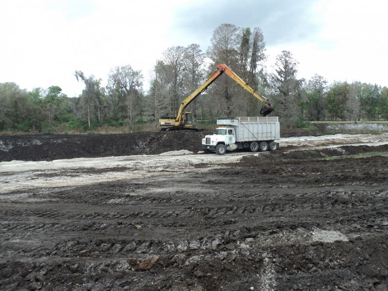 An excavator and truck Peat mining at Little Everglades II Ranch Mine