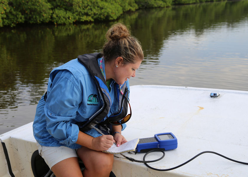 Researcher recording water quality data