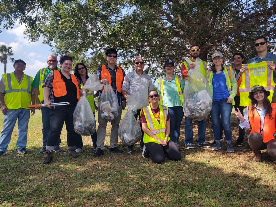 CD employees group photo with collection bags at Festival Park cleanup event