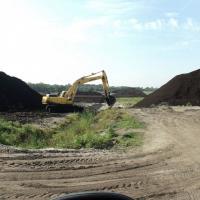 An excavator peat mining at Hurley Mine