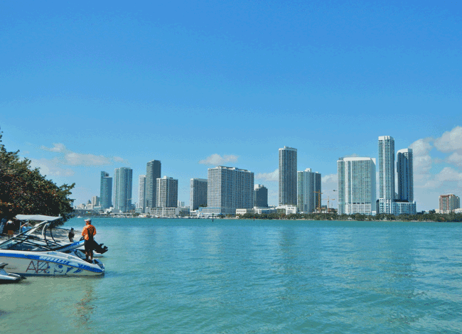 Boaters at an island with Miami Skyline in background