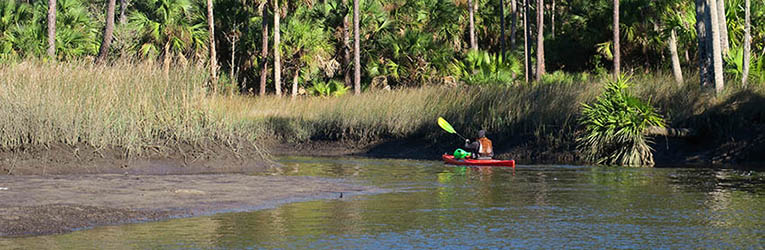Kayaker paddles Shepherd's Creek along Big Bend Coast